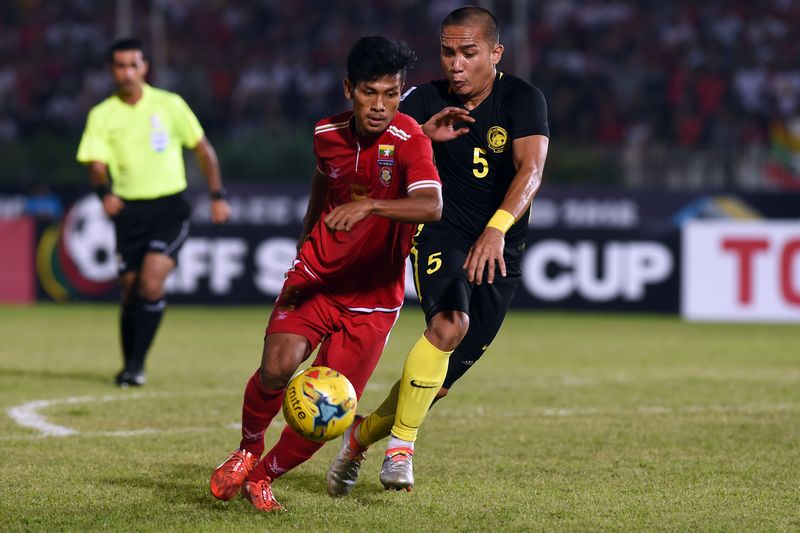 Myanmar's striker Aung Thu (left) and Malaysia's defender Muhammad Shahrom fight for the ball in the AFF Suzuki Cup match in Yangon November 26, 2016. u00e2u20acu201d AFP pic