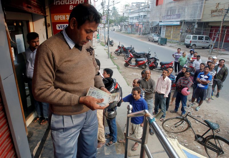 A man counts Indian rupee banknotes after withdrawing them from an ATM in Agartala November 12, 2016. u00e2u20acu201d Reuters pic