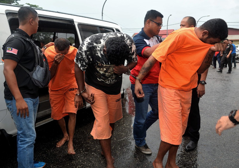 Some of the 14 accused being brought to the Magistrate's Court in Batu Pahat, November 14, 2016 on charges of rioting, kidnapping and murdering a 21-year-old man in May 2012. u00e2u20acu201d Bernama pic