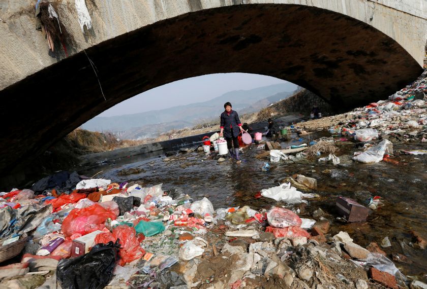 Villagers wash clothes in the garbage-filled Shenling River, in Yuexi county February 14, 2015. u00e2u20acu2022 Reuters pic