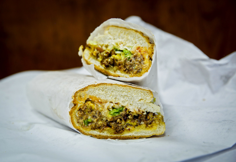 A chopped cheese sandwich, made from griddled ground beef chopped with onions, topped by melted cheese, lettuce, tomatoes and condiments on a hero bun, at Hajji's New York October 17, 2016. u00e2u20acu201d Picture by Michelle V. Agins/The New York Times