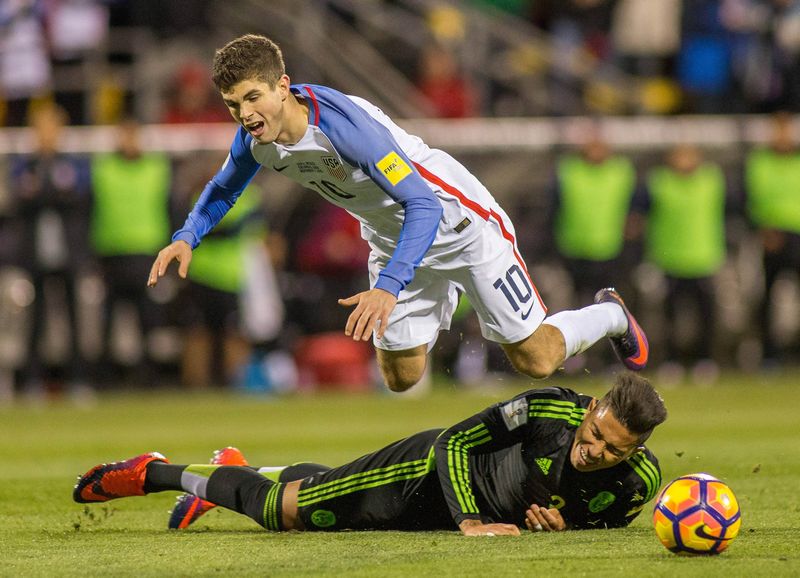 US midfielder Christian Pulisic (No 10) is fouled by Mexico defender Carlos Salcido during the World Cup qualifier at Columbus, Ohio November 11, 2016. u00e2u20acu201d USA TODAY Sports/Reuters picn