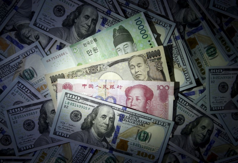South Korean won, Chinese yuan and Japanese yen notes are seen on US 100 dollar notes in this file photo illustration shot December 15, 2015. u00e2u20acu201d Reuters pic