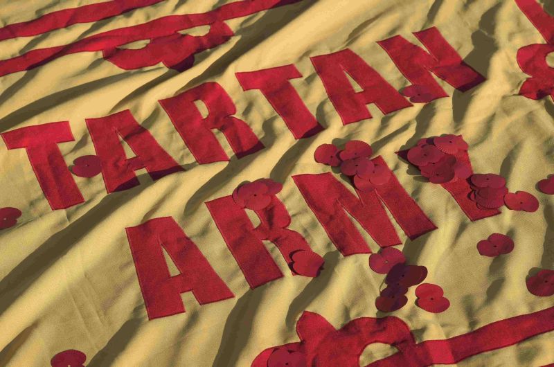 Poppies lie on a Scottish football banner during an Armistice Day event at Trafalgar Square in London November 11, 2016. REUTERS/Toby Melville