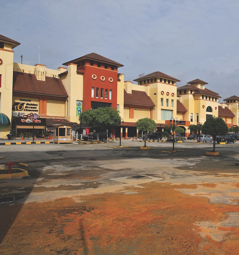 Mud is still seen at the car park at IOI Mall yesterday. Several parked cars were trapped in rising waters on Tuesday. u00e2u20acu201d Picture by Azneal Ishak