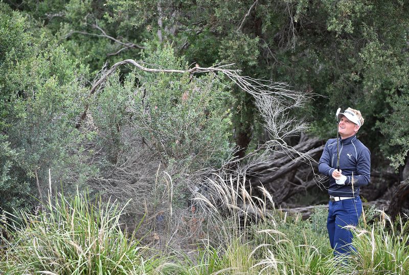 nSoren Kjeldsen of Denmark reacts after chipping out of the bushes during the third day of the World Cup of Golf in Melbourne November 26, 2016. u00e2u20acu201d AFP pic
