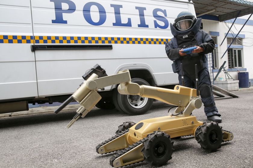 Mohammad Nazrul Dahlan demonstrates how he controls the bomb-detecting robot. — Picture by Choo Choy May