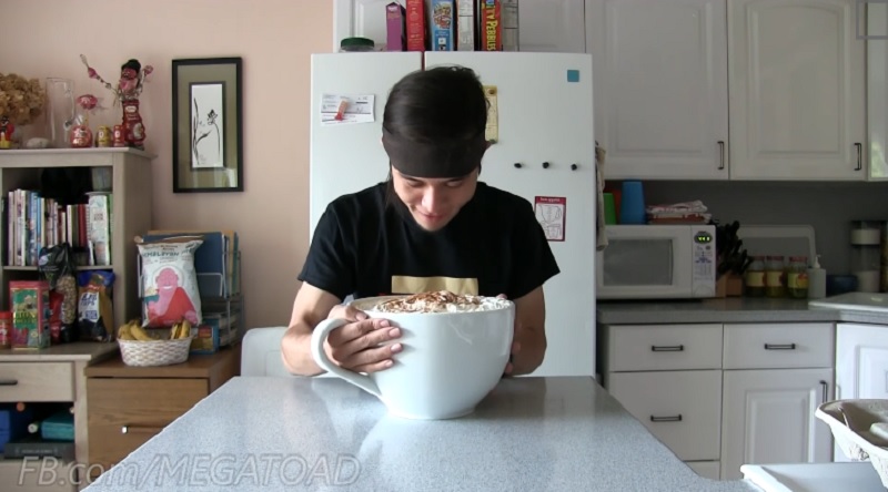 Competitive eater Matt Stonie prepares to drink the giant pumpkin spice latte made up of seven Venti-sized pumpkin spice lattes from Starbucks.
