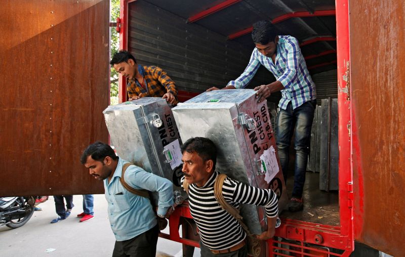 Workers unload boxes carrying Indian currency outside a bank in Chandigarh November 15, 2016. u00e2u20acu2022 Reuters pic