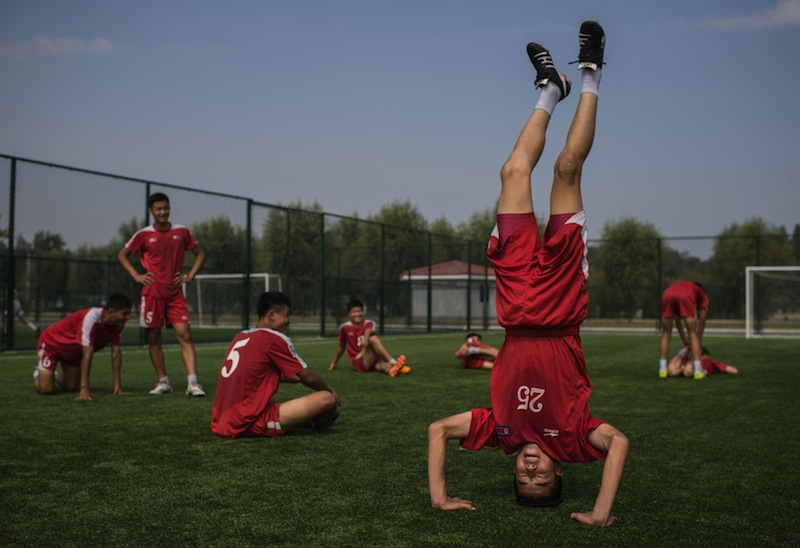 In a photo taken on September 22, 2016, students stretch following an under-14 training session at the Pyongyang International Football School in Pyongyang. u00e2u20acu201d AFP pic