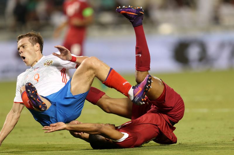 Qatar's Pedro Miguel (right) and Russia's Aleksandr Kokorin take a tumble in a friendly international at Doha November 10, 2016. u00e2u20acu201d Reuters pic