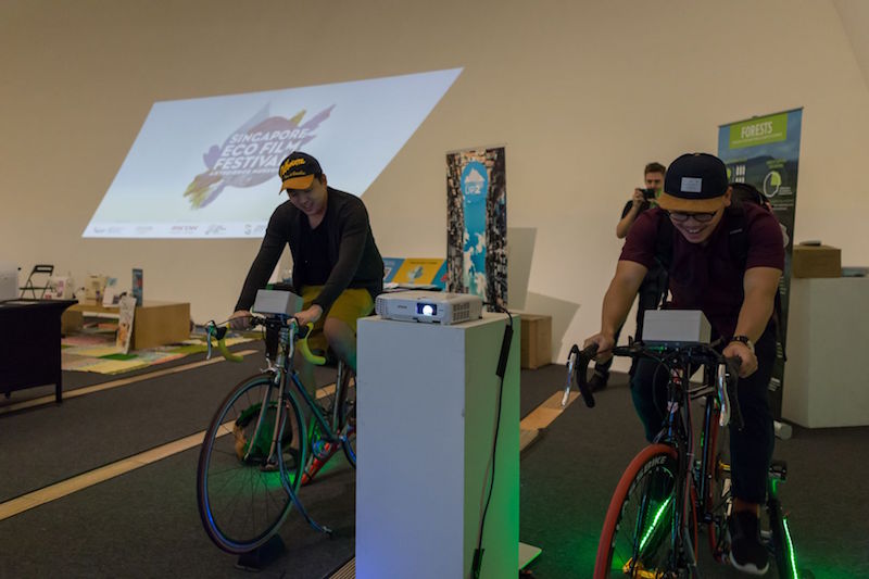 Visitors trying out the pedal-powered projector during the launch of The Singapore Eco Film Festival November 10, 2016. u00e2u20acu201d TODAY pic