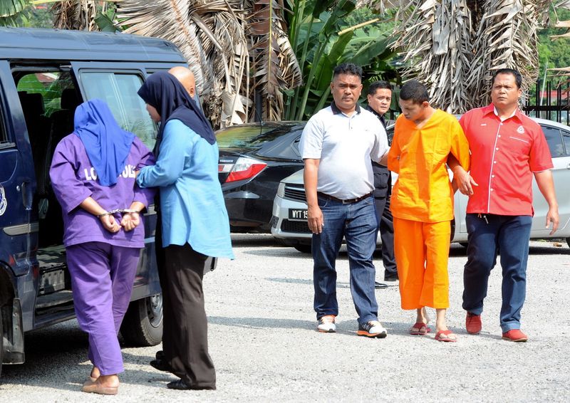 Nor Shahilla Ismail, 23, and Muhammad Firdaus Hamzah, 19, were charged in the Magistrateu00e2u20acu2122s Court in Tangkak, Johor on charges of murdering a forklift driver in Tanjung Gading, Sungai Mati, on November 1, 2016. u00e2u20acu2022 Bernama pic