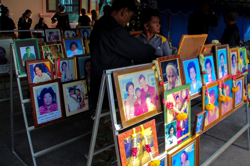 People stand next to pictures of victims of the 2004 tsunami victims during a religious ceremony in Ban Nam Khem in Phang Nga Province, Thailand December 26, 2016.  u00e2u20acu201d Reuters pic