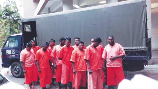 Gang 21 members being rounded up by Bukit Aman special team in Kuala Selangor on Tuesday. u00e2u20acu201d Picture by Malay Mail 