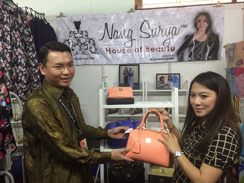 Former aide to Datuk Seri Anwar Ibrahim, Saiful Bukhari Azlan and wife at their booth during the Umno General Assembly in PWTC. u00e2u20acu201d Picture by Kamles Kumar 