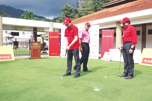 (From left) Eqhwan, C. Sivanandan, executive director, SportExcel and Syed Anuar Syed Ali, head for Ambanku00e2u20acu2122s group corporate communications and marketing, putting during the launch. u00e2u20acu201d Picture by Malay Mail