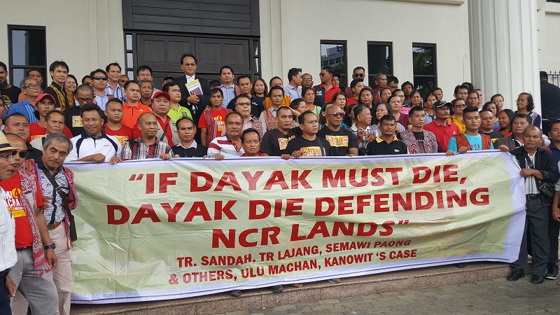 The Dayak landowners, who come from all over Sarawak, with a banner outside Kuching High Court complex, giving their support to the headman Sandah anak Tabau and seven other landowners in Kuching December 20, 2016. u00e2u20acu201d Picture by Sulok Tawie 