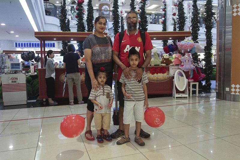 Jagjit Singh poses with his family at a supermarket in Kuala Lumpur. u00e2u20acu201d Picture by Yusof Mat Isa