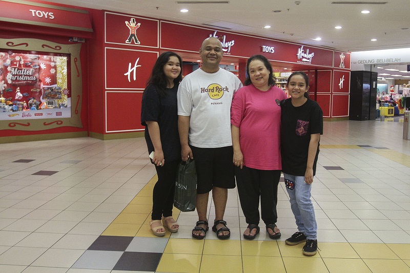 Annuar Rizwan poses with his family at a supermarket in Kuala Lumpur.
