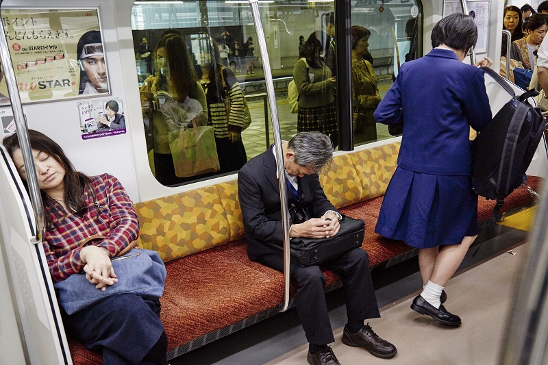 Commuters sleep on a train in Tokyo, October 21, 2016. u00e2u20acu201d Picture by Ko Sasaki/The New York Times
