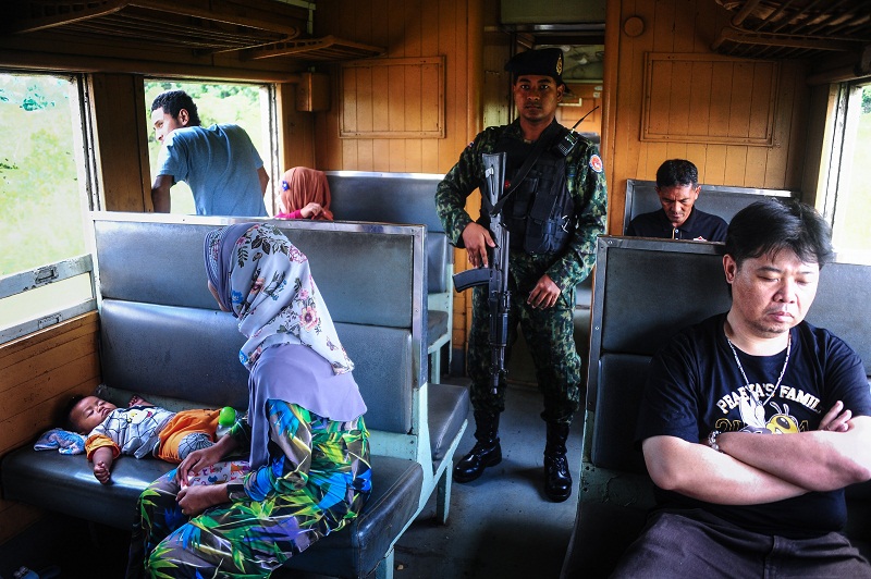 This picture taken on November 21, 2016 shows a volunteer ranger on patrol in the carriage of a train passing through the restive southern Thai province of Narathiwat. u00e2u20acu201d AFP pic