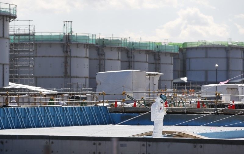 A worker takes notes in front of storage tanks for radioactive water at Tokyo Electric Power Co's (TEPCO) tsunami-crippled Fukushima Daiichi nuclear power plant in Okuma town, Fukushima prefecture, Japan. u00e2u20acu2022 Reuters pic