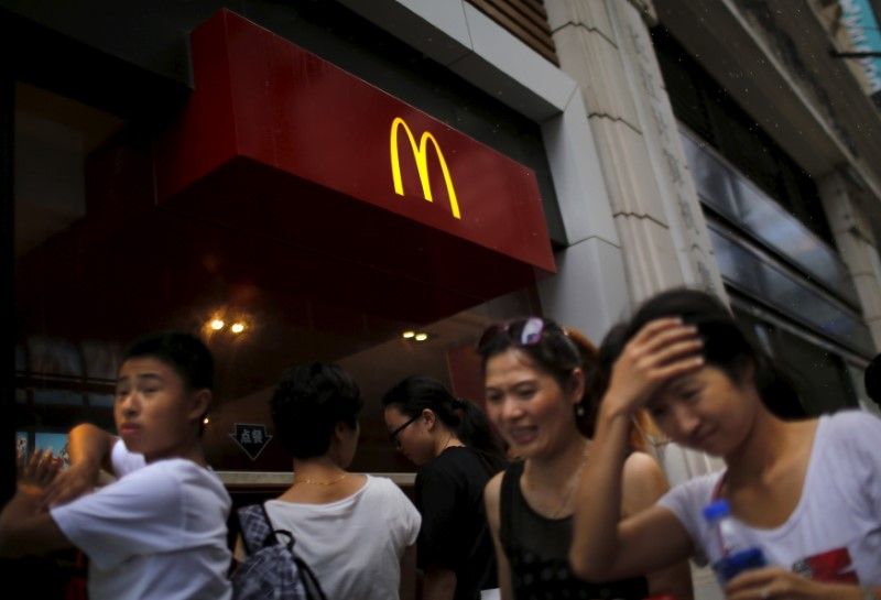 People walk by a McDonald's store in downtown Shanghai July 31, 2014. REUTERS/Carlos Barria/File Photo