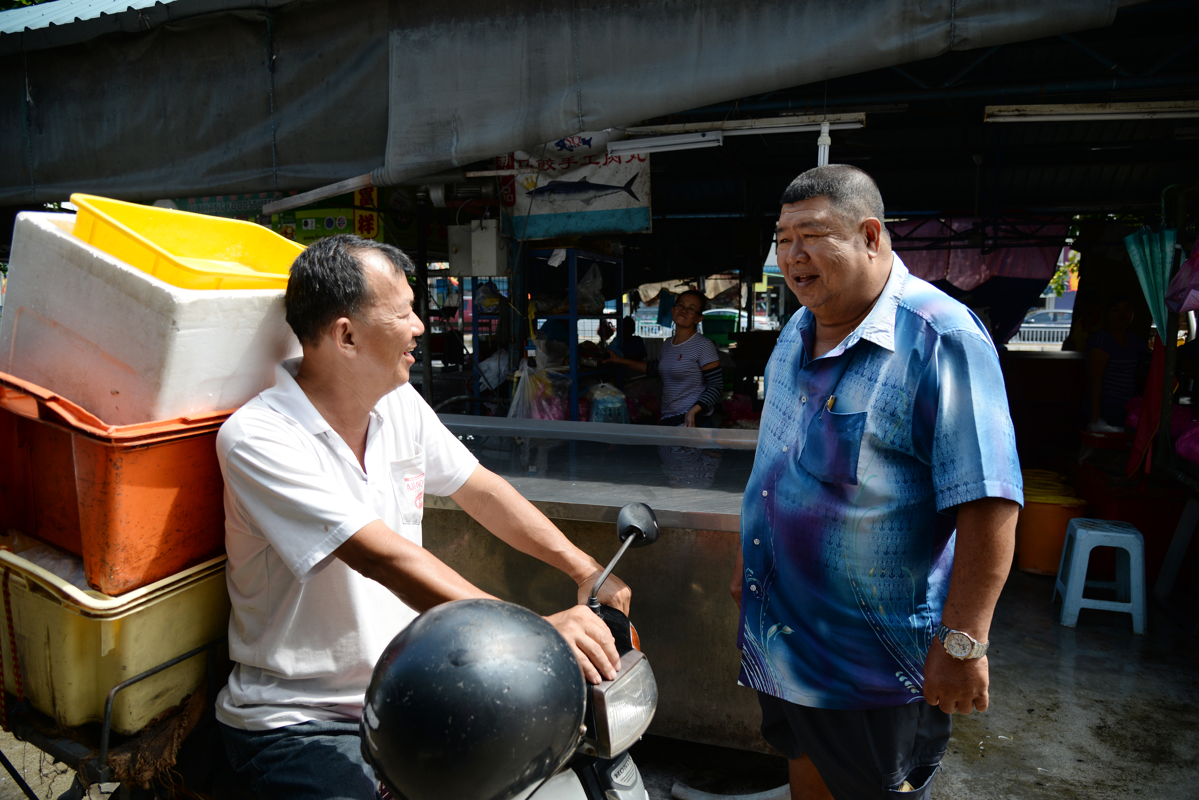 Ong Kim Seng talking to a fellow trader at the market. — Picture by K.E.Ooi