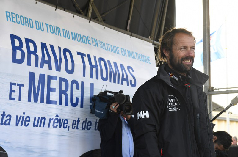 People surround French skipper Thomas Coville smiles on a stage following his arrival in the port of Brest, western France, on December 26, 2016, after beating the record in solo non-stop round the world sailing. u00e2u20acu201d AFP pic