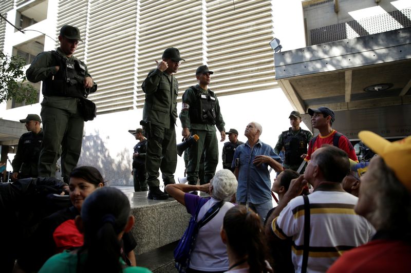 Venezuelan National Guards control the crowd as people queue to deposit their 100 bolivar notes, outside Venezuela's Central Bank in Caracas December 16, 2016. u00e2u20acu201d Reuters pic