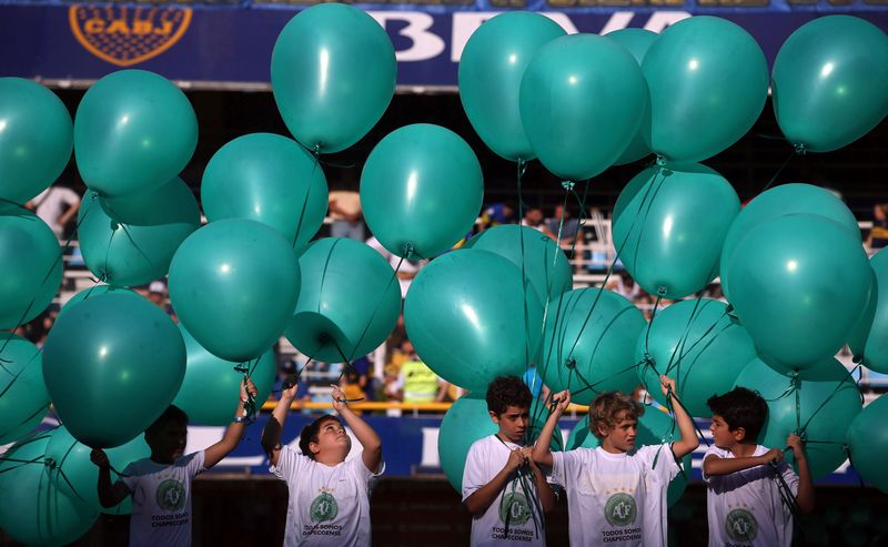 Children hold green balloons and wear T-shirts with the shield of Brazilian football team Chapecoense in Buenos Aires December 4, 2016 to pay tribute to the victims of the plane crash in Colombia. u00e2u20acu201d Reuters pic  