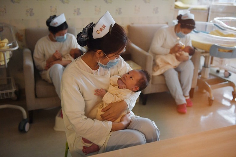 Nurses hold babies at the Xiyuege Centre, or u00e2u20acu02dcLucky Month Homeu00e2u20acu2122, in Beijing December 13, 2016. u00e2u20acu201d AFP pic