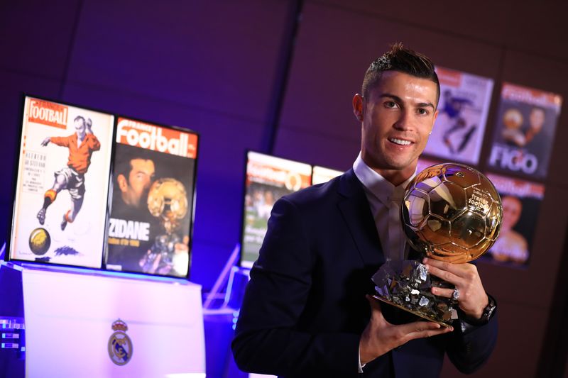 Handout photo released on December 12, 2016 by L'Equipe shows Portuguese player Cristiano Ronaldo posing with the Ballon d'Or France Football trophy in Madrid. u00e2u20acu201d AFP pic