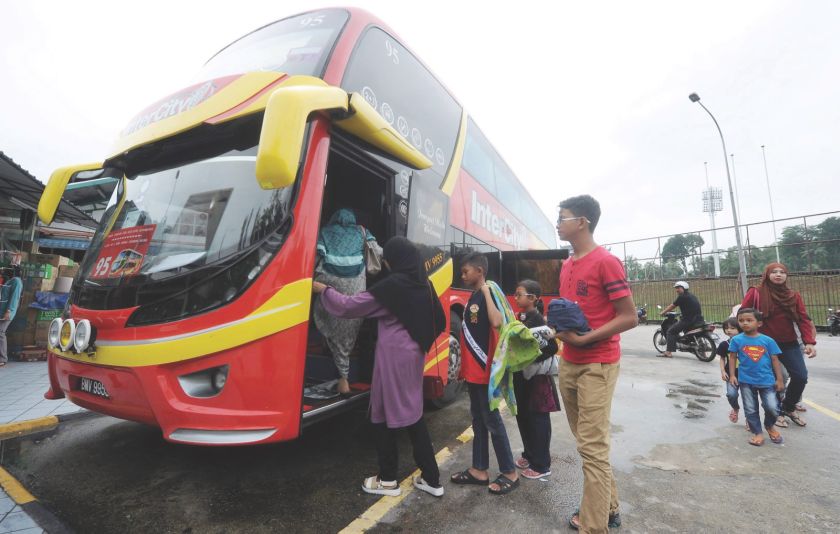 Passengers board an express bus at Duta bus terminal yesterday. The industry is under scrutiny again after the Pagoh tragedy which claimed 14 lives. u00e2u20acu201d Picture by Mukhriz Hazim 