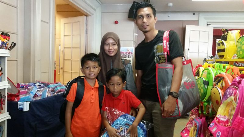 Farun Fadhlida Harun, 32, and her husband Mohamad Lokman Hamid, 33, buys school supplies in Kuala Lumpur every year during sales. u00e2u20acu2022 Picture by Ida Lim