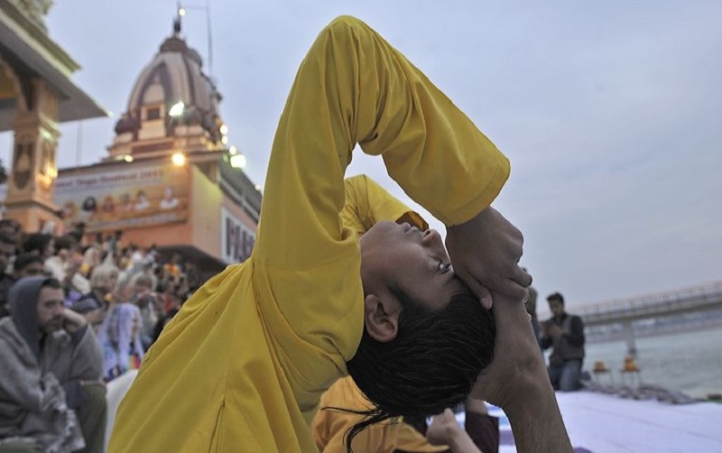 A Hindu yoga student performs a yoga exercise during the inauguration ceremony of the international yoga festival. u00e2u20acu201d AFP pic