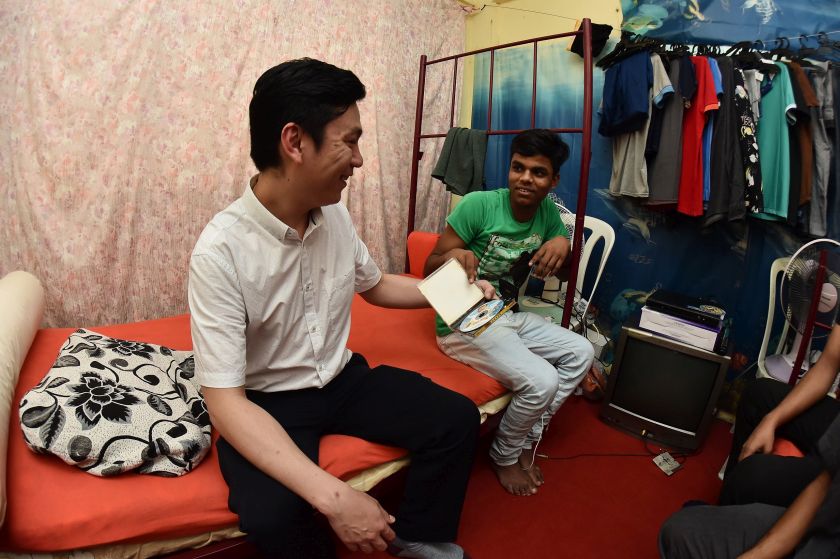 Rakesh shows Lee a CD of Nepalese music... Rakesh works in a factory making ice cream and likes visiting KLCC on his day off. 