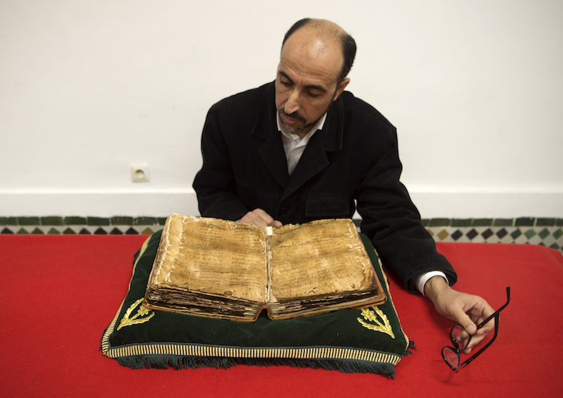 A man reads an encyclopaedia about Maliki Muslim doctrine at the al-Qarawyin Library. u00e2u20acu201d AFP pic