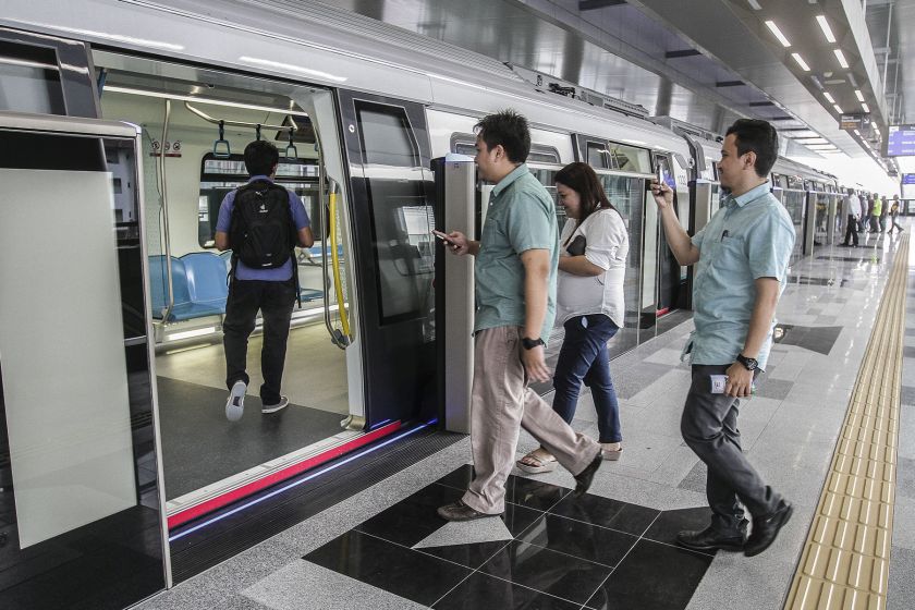 Commuters catch a ride on the maiden MRT service, which will be free to the public for a period of one month.