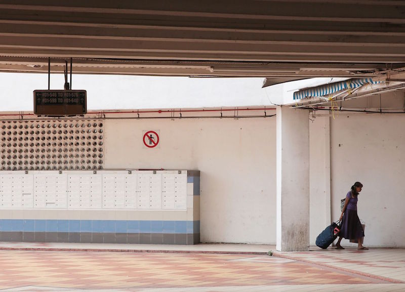 Long-time resident Madam Tay, 70, leaves with her belongings after handing over the keys of her four-room flat at Rochor Centre yesterday. u00e2u20acu201d TODAY pic