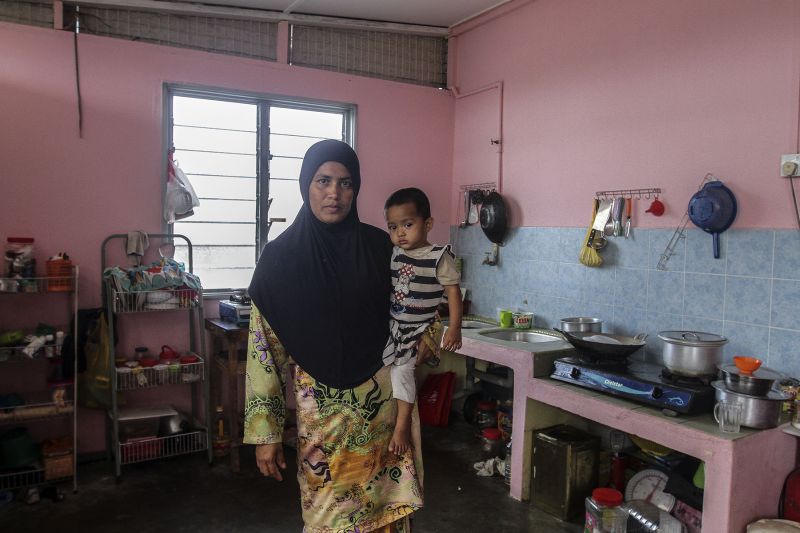 Abdul Rahman's wife, Aminah Khatu, in the kitchen her family shares with another Rohingya family.