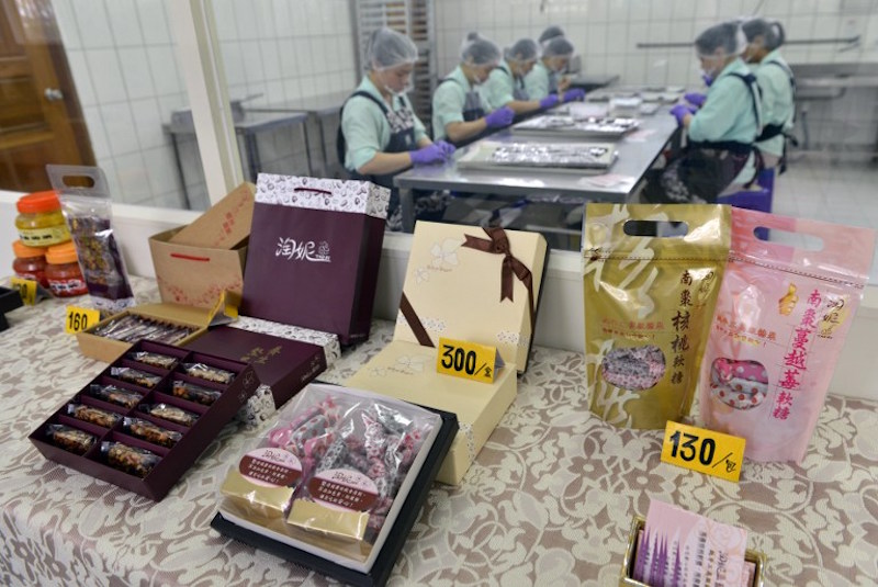 Food items made by prisoners are seen on display as inmates work in the background at a correctional facility in Taoyuan, northern Taiwan, November 24, 2016. u00e2u20acu201d AFP pic