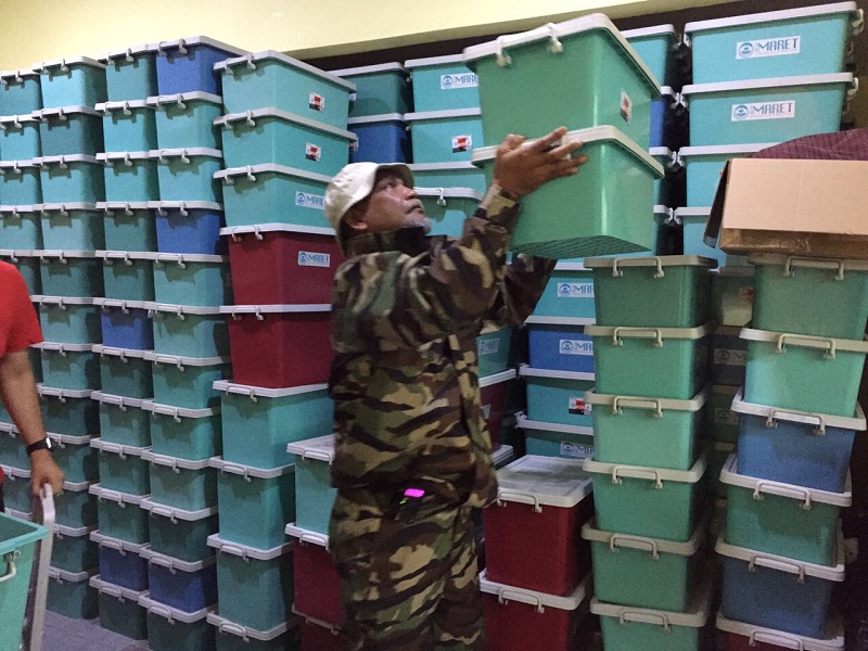 A man moves hygiene kits prepared by Imaret.