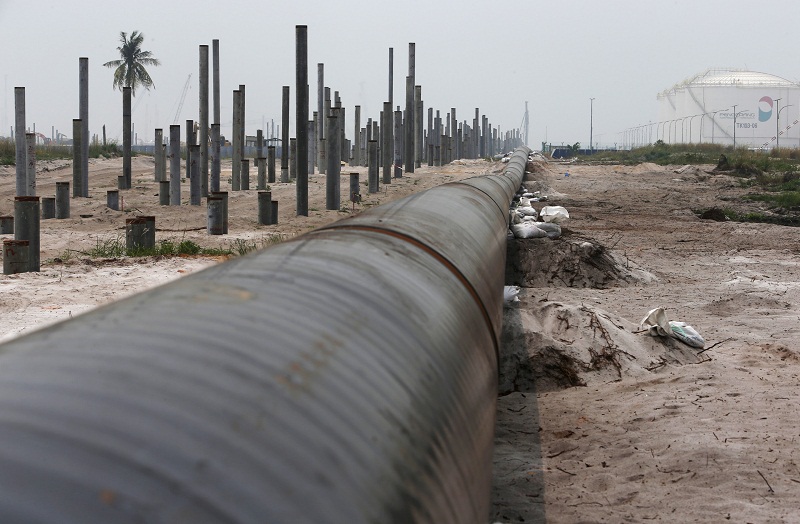 An oil pipeline is laid next to the Vopak-Dialogue oil storage facility (right) and a Refinery and Petrochemical Integrated Development (RAPID) project construction site in Pangerang, Johor October 6, 2015. u00e2u20acu201d Reuters pic