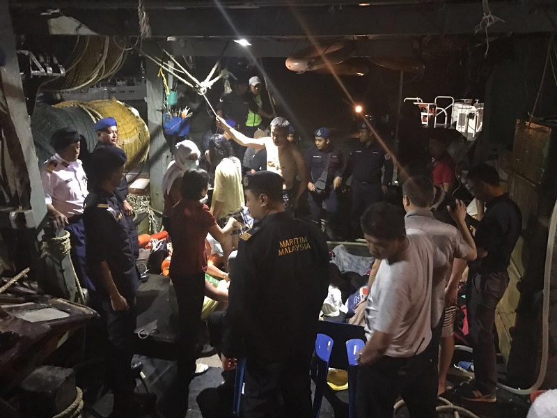 Chinau00e2u20acu2122s consul general in Sabah Chen Peijie (left, in red) onboard the fishing trawler, talking to the Chinese nationals who were onboard a catamaran that sank on the first day of Chinese New Year. Picture taken January 30, 2017. u00e2u20acu201d Picture by Julia Ch