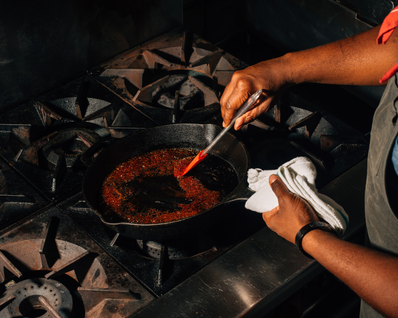 Rawlston Williams burns sugar to marinate and braise lamb shanks, mimicking the meaty colouring and elemental flavour of meats roasted over a fire, at the Food Sermon in Brooklyn, January 18, 2017.