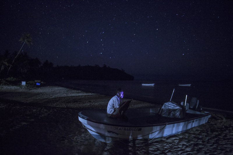 A man uses his phone in the village of Denimanu on the Fijian Island of Yadua January 3, 2017. The skills for hunting turtles, passed down through the generations on the island, come in handy for tracking and protecting them from illegal harvesting. — Picture by Lam Yik Fei/The New York Times