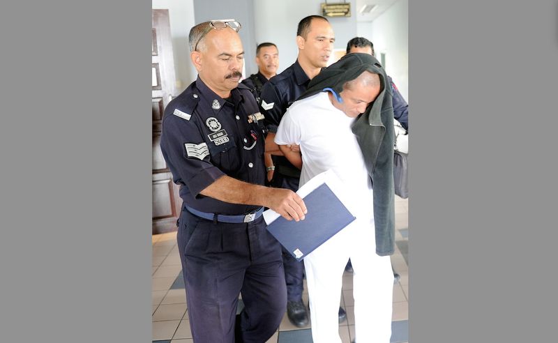 Policemen led away Khairul Nordin after he was sentenced to death by the Malacca High Court, January 27, 2017, for the murder of his brother-in-law. u00e2u20acu201d Bernama pic