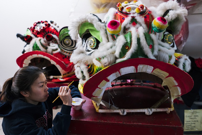 Kelly Wong, a member of the New York Chinese Freemasons Athletic Club’s dance troupe, paints a lion head in New York, January 14, 2017. A lion head figure typically weighs under 10 pounds and sits squarely on the dancer’s shoulders. — Picture by An Rong Xu/The New York Times 